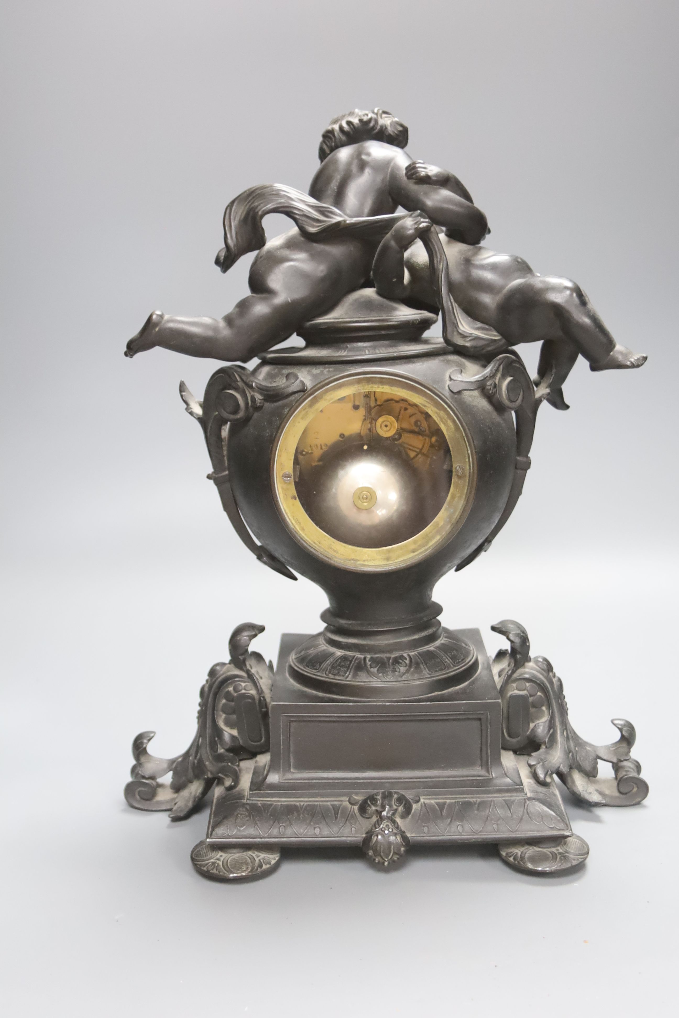 A Victorian spelter cherub mantel clock, height 39cm